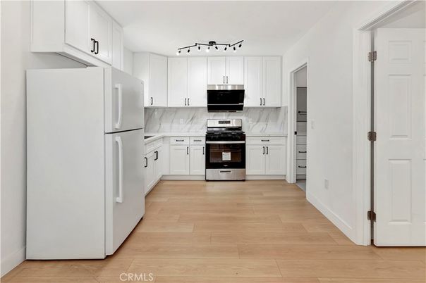 Interior, Kitchen, Marble Walls, Stainless Steel Appliances, Wood Texture Flooring