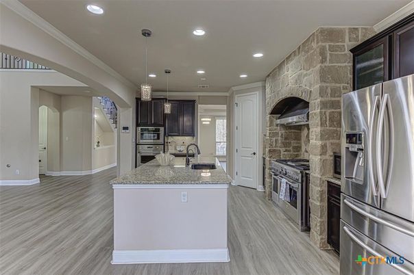 Interior, Kitchen, Pendant Lights, Recessed Lighting, Stainless Steel Appliances, Stone Walls, Wood Texture Flooring