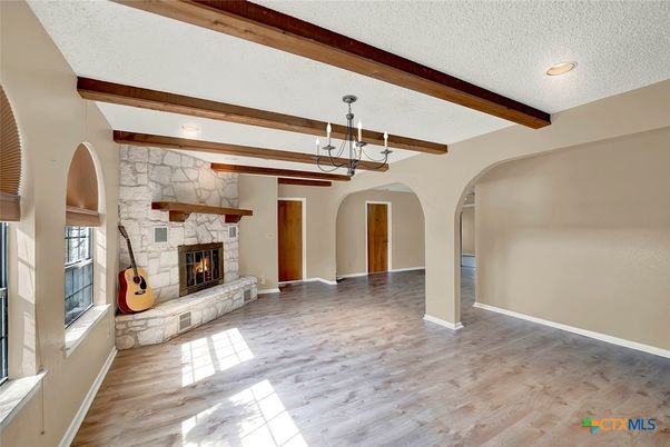 Empty room, Fireplace, Interior, Pendant Lights, Recessed Lighting, Stone Walls, Wooden Beams, Wood Texture Flooring