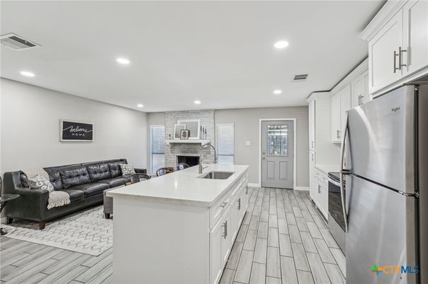 Fireplace, Interior, Kitchen, Living room, Recessed Lighting, Stainless Steel Appliances, Wood Texture Flooring