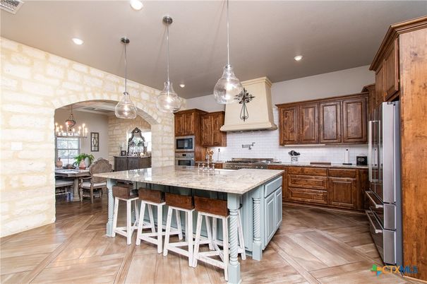 Dining room, Interior, Kitchen, Pendant Lights, Recessed Lighting, Stainless Steel Appliances, Stone Walls, Wood Texture Flooring