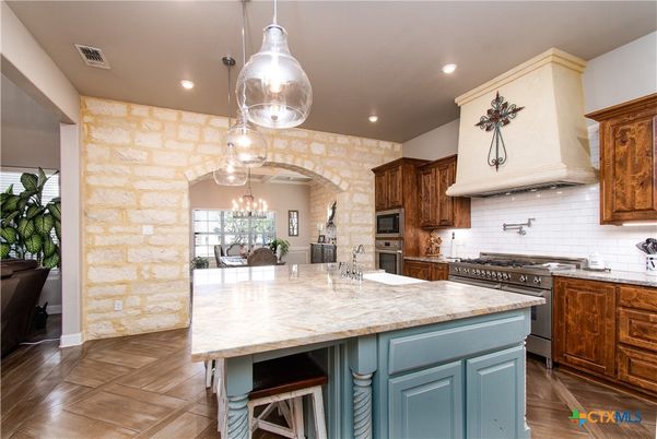 Chandelier, Dining room, Interior, Kitchen, Pendant Lights, Recessed Lighting, Stainless Steel Appliances, Stone Walls, Wood Texture Flooring