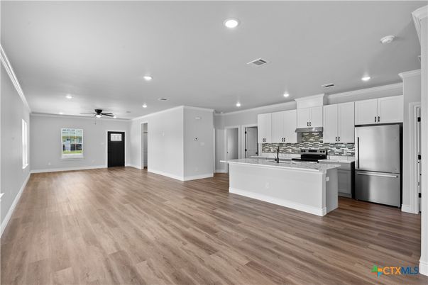 Empty room, Interior, Kitchen, Recessed Lighting, Stainless Steel Appliances, Wood Texture Flooring