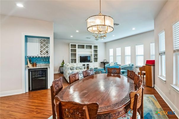 Chandelier, Dining room, Fireplace, Interior, Living room, Pendant Lights, Recessed Lighting, Wood Texture Flooring