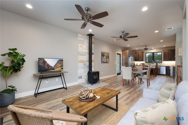 Dining room, Fireplace, Interior, Living room, Recessed Lighting, Stone Walls, Wood Texture Flooring