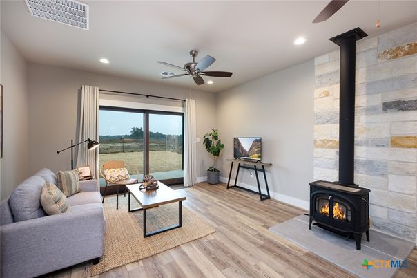 Fireplace, Interior, Living room, Recessed Lighting, Stone Walls, Wood Texture Flooring