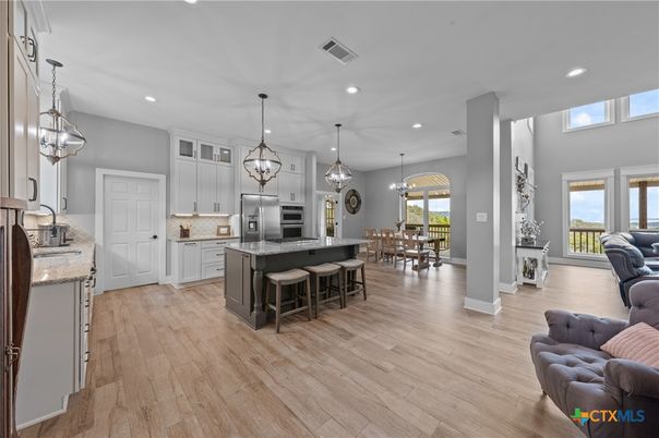Chandelier, Dining room, Interior, Kitchen, Pendant Lights, Recessed Lighting, Stainless Steel Appliances, Wood Texture Flooring