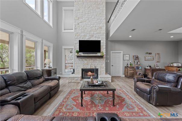 Fireplace, Interior, Living room, Recessed Lighting, Stone Walls, Wood Texture Flooring