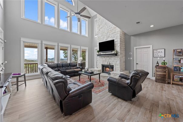Fireplace, Interior, Living room, Recessed Lighting, Stone Walls, Wood Texture Flooring