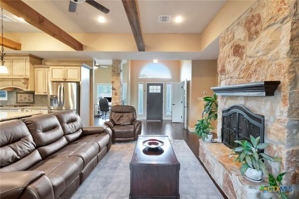 Fireplace, Interior, Kitchen, Living room, Pendant Lights, Recessed Lighting, Stainless Steel Appliances, Stone Walls, Wooden Beams