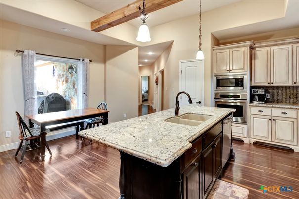 Dining room, Interior, Kitchen, Pendant Lights, Recessed Lighting, Stainless Steel Appliances, Wooden Beams, Wood Texture Flooring