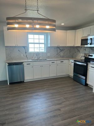 Interior, Kitchen, Marble Walls, Pendant Lights, Recessed Lighting, Stainless Steel Appliances, Wood Texture Flooring