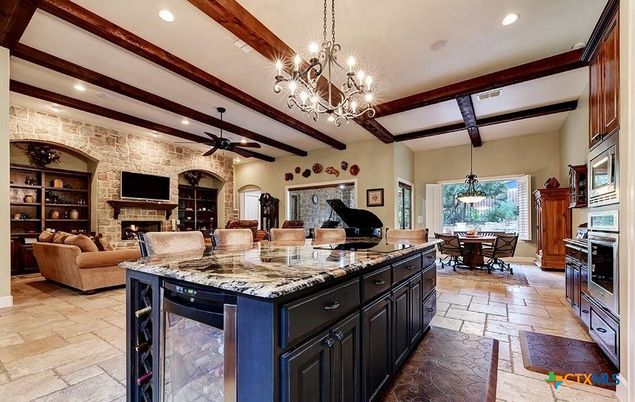 Chandelier, Dining room, Fireplace, Interior, Kitchen, Living room, Pendant Lights, Piano, Recessed Lighting, Stone Walls, Wooden Beams