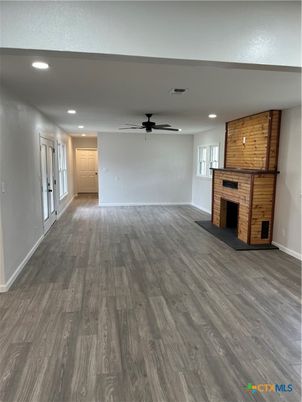 Empty room, Fireplace, Interior, Recessed Lighting, Stone Walls, Wood Texture Flooring