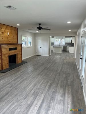 Empty room, Fireplace, Interior, Kitchen, Pendant Lights, Recessed Lighting, Wood Texture Flooring, Wooden Walls