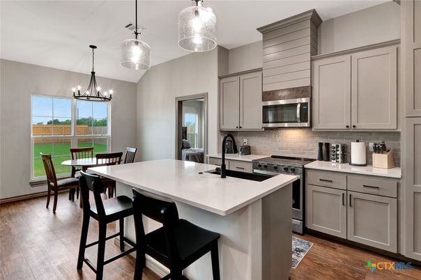 Chandelier, Dining room, Interior, Kitchen, Pendant Lights, Stainless Steel Appliances, Wood Texture Flooring