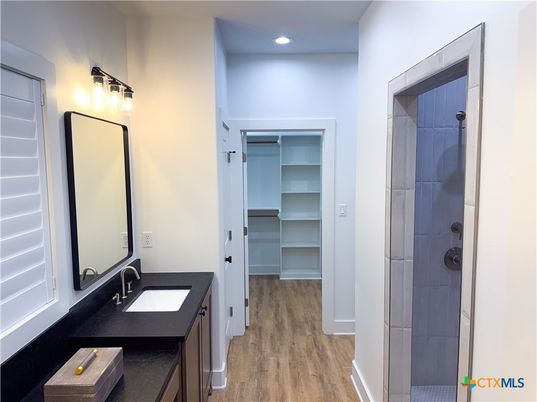 Bathroom, Dual Sink Vanities, Glass Shower, Interior, Recessed Lighting, Wood Texture Flooring