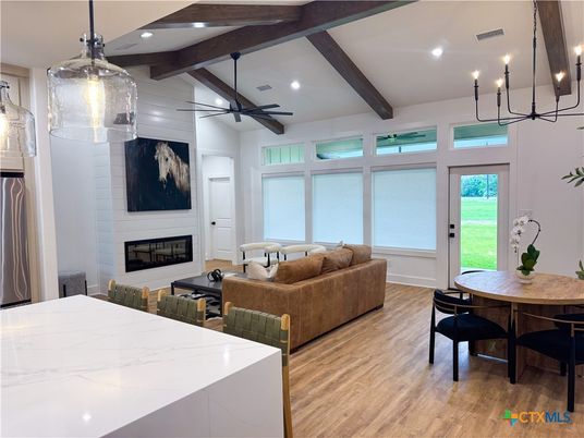 Chandelier, Dining room, Fireplace, Interior, Living room, Pendant Lights, Recessed Lighting, Wooden Beams, Wood Texture Flooring