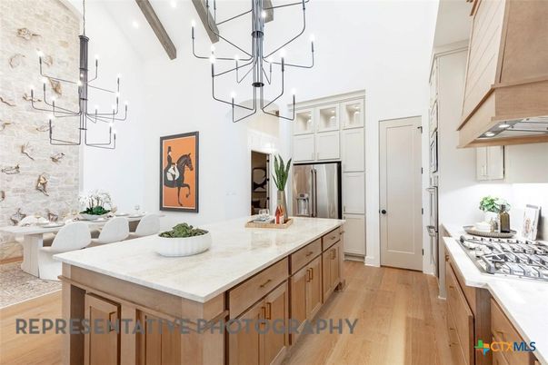 Chandelier, Dining room, Interior, Kitchen, Pendant Lights, Stainless Steel Appliances, Stone Walls, Wooden Beams, Wood Texture Flooring