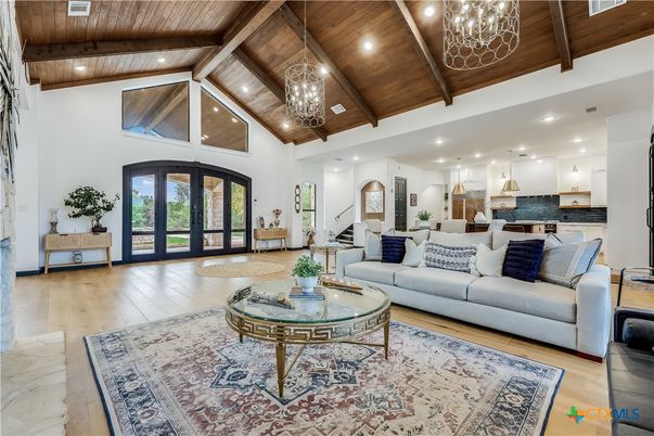 Chandelier, Interior, Kitchen, Living room, Pendant Lights, Recessed Lighting, Stainless Steel Appliances, Wooden Beams, Wooden Ceilings, Wood Texture Flooring