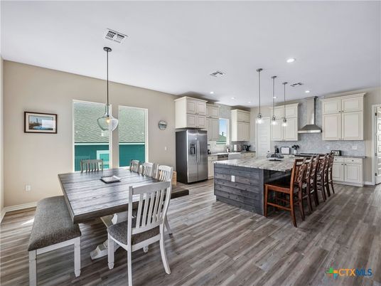 Dining room, Interior, Kitchen, Pendant Lights, Recessed Lighting, Stainless Steel Appliances, Wood Texture Flooring