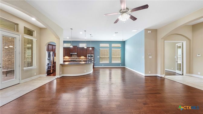 Empty room, Interior, Kitchen, Pendant Lights, Recessed Lighting, Stainless Steel Appliances, Wood Texture Flooring