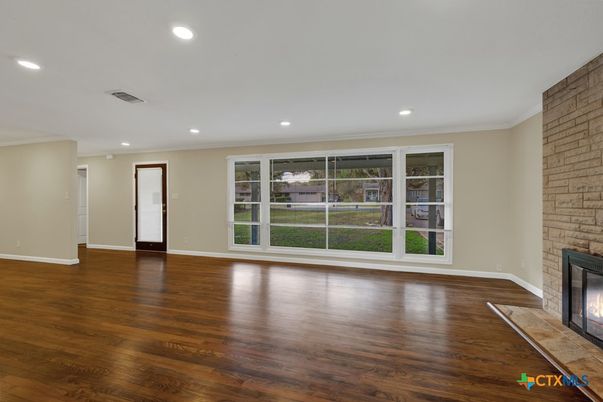 Empty room, Fireplace, Interior, Recessed Lighting, Stone Walls, Wood Texture Flooring