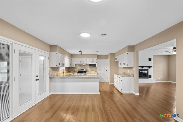 Fireplace, Interior, Kitchen, Recessed Lighting, Stainless Steel Appliances, Wood Texture Flooring