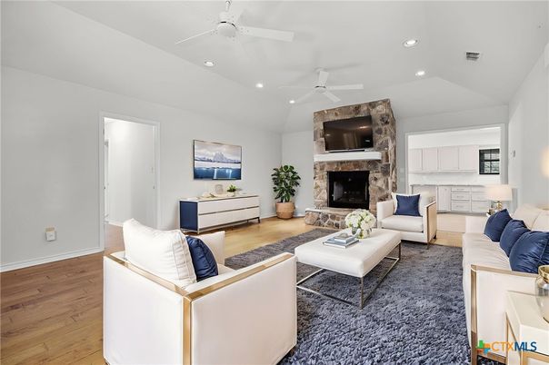 Fireplace, Interior, Living room, Recessed Lighting, Stone Walls, Wood Texture Flooring