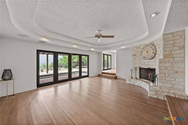 Empty room, Fireplace, Interior, Recessed Lighting, Stone Walls, Wood Texture Flooring