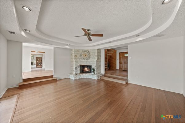 Empty room, Fireplace, Interior, Recessed Lighting, Stone Walls, Wood Texture Flooring