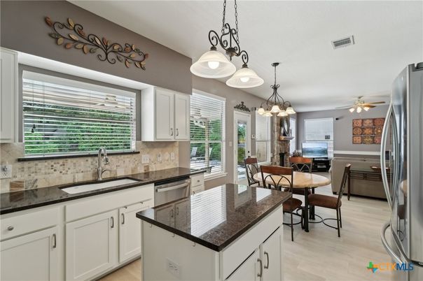Chandelier, Dining room, Interior, Kitchen, Pendant Lights, Stainless Steel Appliances, Wood Texture Flooring