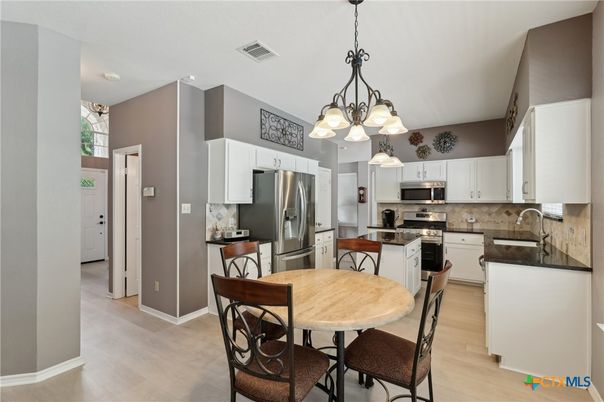 Chandelier, Dining room, Interior, Kitchen, Pendant Lights, Stainless Steel Appliances, Wood Texture Flooring