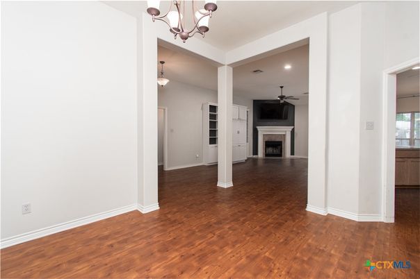 Chandelier, Empty room, Fireplace, Interior, Recessed Lighting, Wood Texture Flooring