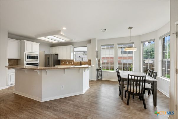 Dining room, Interior, Kitchen, Pendant Lights, Recessed Lighting, Stainless Steel Appliances, Wood Texture Flooring
