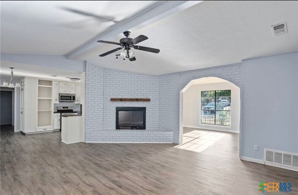 Empty room, Fireplace, Interior, Kitchen, Stainless Steel Appliances, Stone Walls, Wood Texture Flooring