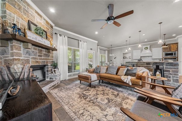 Fireplace, Interior, Kitchen, Living room, Pendant Lights, Recessed Lighting, Stainless Steel Appliances, Stone Walls, Wood Texture Flooring