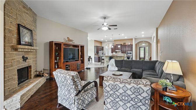 Fireplace, Interior, Kitchen, Living room, Pendant Lights, Recessed Lighting, Stainless Steel Appliances, Stone Walls, Wood Texture Flooring