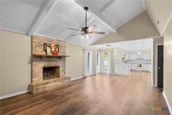 Empty room, Fireplace, Interior, Kitchen, Pendant Lights, Recessed Lighting, Stone Walls, Wood Texture Flooring