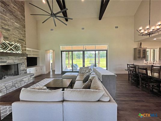 Chandelier, Dining room, Fireplace, Interior, Living room, Pendant Lights, Stone Walls, Wooden Beams, Wood Texture Flooring