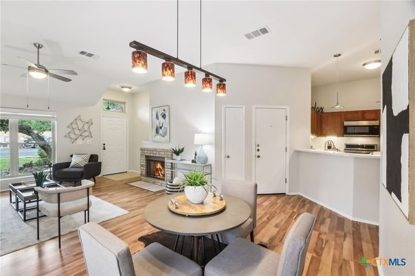 Dining room, Fireplace, Interior, Kitchen, Living room, Pendant Lights, Stainless Steel Appliances, Wood Texture Flooring