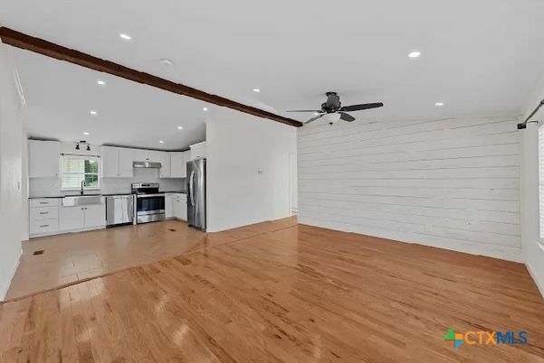 Empty room, Interior, Kitchen, Recessed Lighting, Stainless Steel Appliances, Wood Texture Flooring