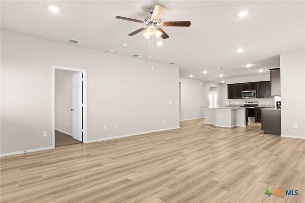 Empty room, Interior, Kitchen, Recessed Lighting, Stainless Steel Appliances, Wood Texture Flooring