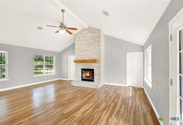 Empty room, Fireplace, Interior, Recessed Lighting, Stone Walls, Wood Texture Flooring