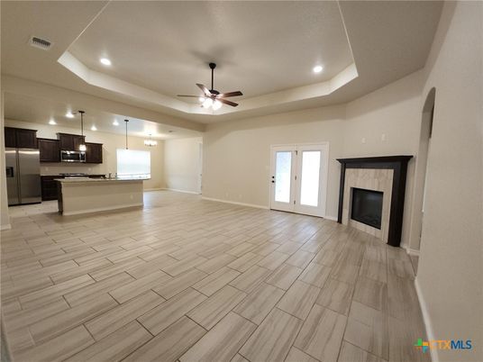 Empty room, Fireplace, Interior, Kitchen, Pendant Lights, Recessed Lighting, Stainless Steel Appliances, Wood Texture Flooring