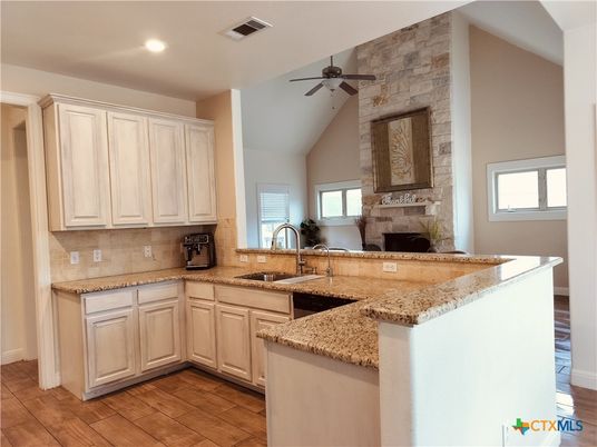 Fireplace, Interior, Kitchen, Recessed Lighting, Stone Walls, Wood Texture Flooring