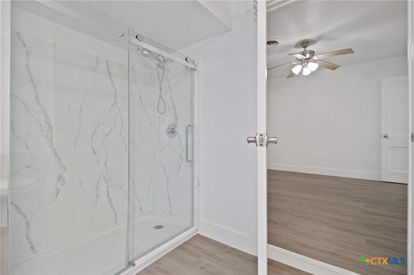 Bathroom, Glass Shower, Interior, Marble Walls, Wood Texture Flooring
