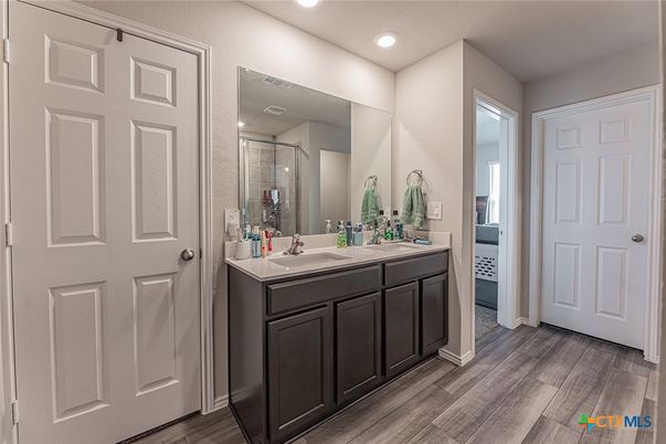 Bathroom, Dual Sink Vanities, Glass Shower, Interior, Recessed Lighting, Wood Texture Flooring