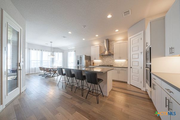 Dining room, Interior, Kitchen, Pendant Lights, Recessed Lighting, Stainless Steel Appliances, Wood Texture Flooring