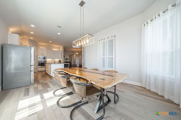 Dining room, Interior, Kitchen, Pendant Lights, Recessed Lighting, Stainless Steel Appliances, Wood Texture Flooring